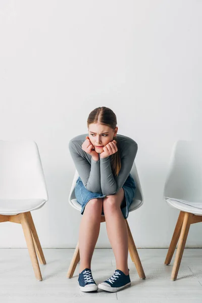 Pensive girl waiting for job interview in office — Stock Photo