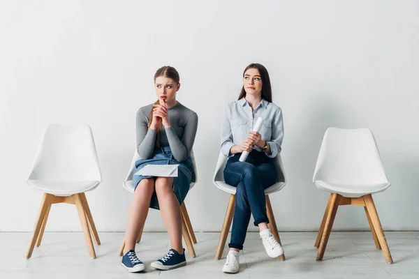 Thoughtful candidates with resume waiting for job interview in office — Stock Photo