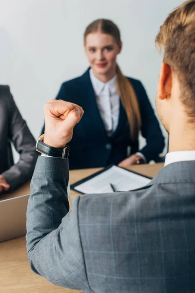 Selective focus of employee showing yes gesture during job interview in office — Stock Photo