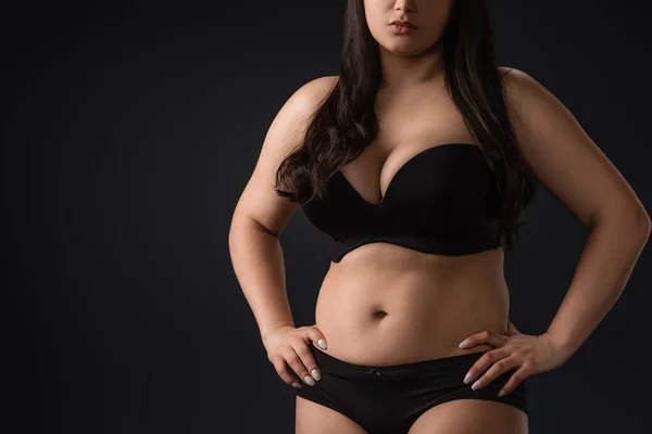 Cropped view of young size plus woman in underwear on black background — Stock Photo