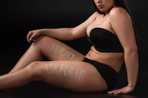 Cropped view of plus size model with lettering I Did not Ask For It on body on black background — Stock Photo