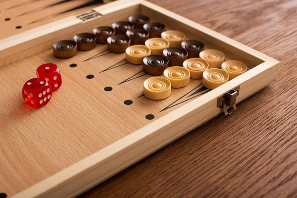 KYIV, UKRAINE - JANUARY 30, 2019: backgammon board with checkers and dice pair on wooden table — Stock Photo