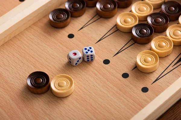 KYIV, UKRAINE - JANUARY 30, 2019: wooden backgammon board with checkers and dice pair — Stock Photo