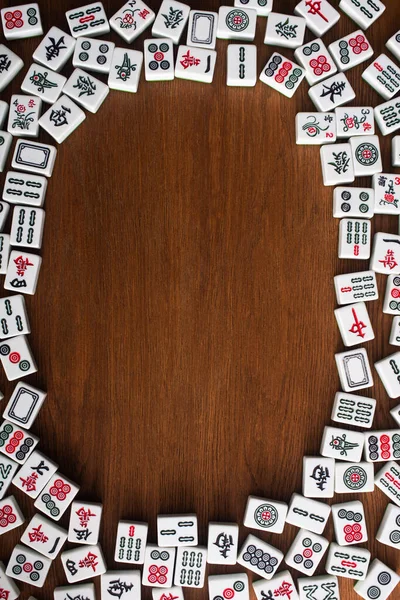 KYIV, UKRAINE - JANUARY 30, 2019: frame of white mahjong game tiles on wooden table, top view — Stock Photo