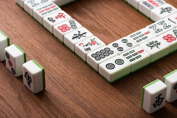 KYIV, UKRAINE - JANUARY 30, 2019: selective focus of mahjong game tiles rows on wood table — Stock Photo