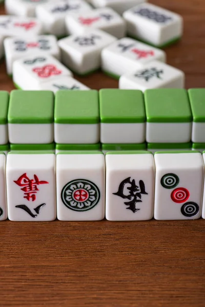 KYIV, UKRAINE - JANUARY 30, 2019: selective focus of mahjong game tiles with signs and symbols on wooden table — Stock Photo