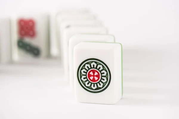 KYIV, UKRAINE - JANUARY 30, 2019: selective focus of mahjong game tiles on white background — стокове фото