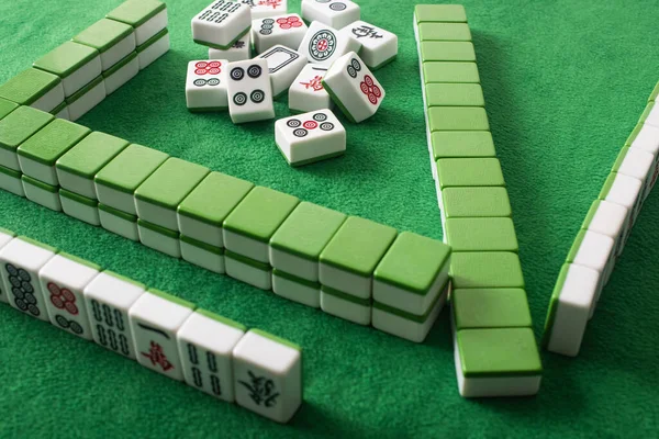 KYIV, UKRAINE - 30 JANVIER 2019 : rangées et pile de tuiles de jeu de mahjong sur la surface de velours vert — Photo de stock