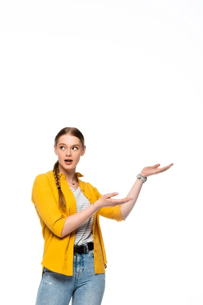 Surprised pretty girl with braid pointing with hands aside isolated on white — Stock Photo