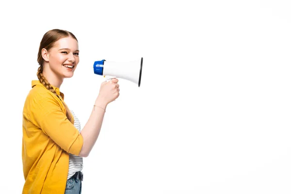 Side view of smiling pretty girl with braid holding loudspeaker isolated on white — Stock Photo