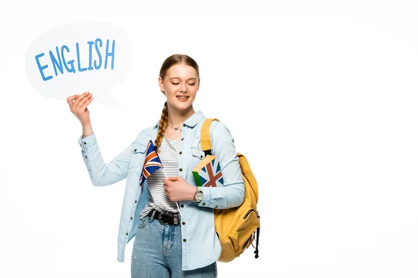 Bella studentessa sorridente con zaino in possesso di libro, bolla discorso con scritte in inglese e bandiera britannica isolata su bianco — Foto stock