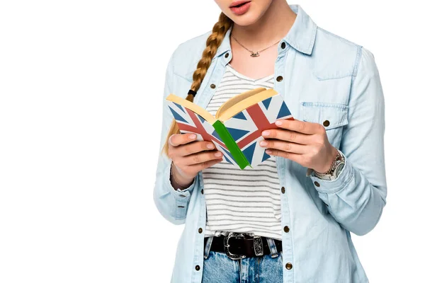 Vista cortada de menina com livro de leitura de trança com bandeira do Reino Unido isolado no branco — Fotografia de Stock