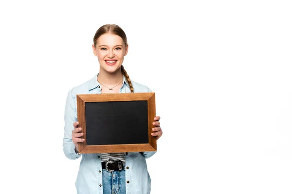 Smiling pretty girl with braid holding empty chalkboard isolated on white — Stock Photo