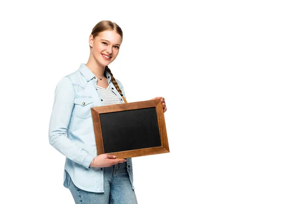 Smiling pretty girl with braid holding empty chalkboard isolated on white — Stock Photo