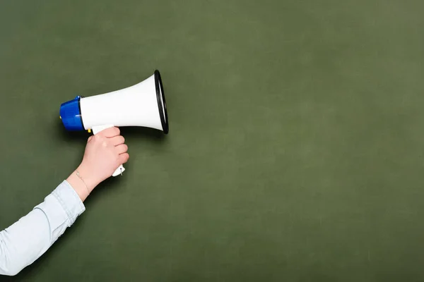 Cropped view of woman holding loudspeaker on chalkboard background — Stock Photo