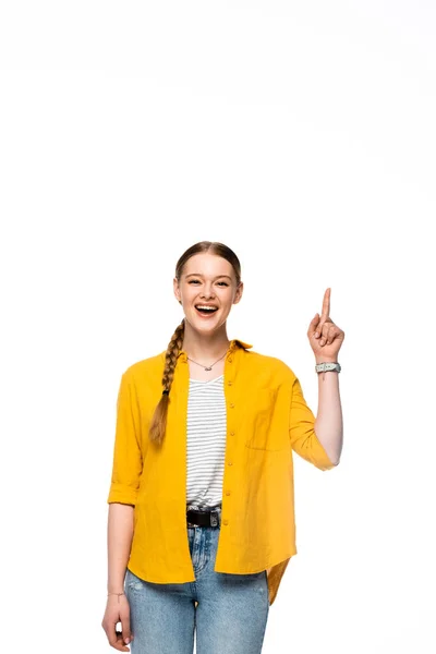 Happy attractive girl with braid and open mouth showing idea gesture isolated on white — Stock Photo