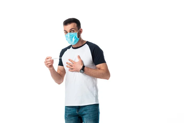 Sick man in medical mask holding digital thermometer and standing isolated on white — Stock Photo