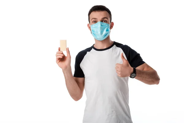 Man in medical mask showing thumb up and holding soap bar isolated on white — Stock Photo