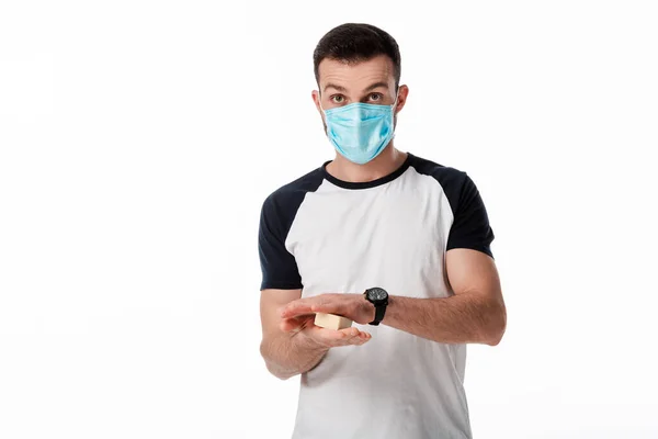 Man in medical mask holding soap bar isolated on white — Stock Photo