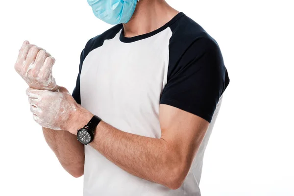 Vista cortada do homem em azul máscara médica lavar as mãos isoladas no branco — Fotografia de Stock