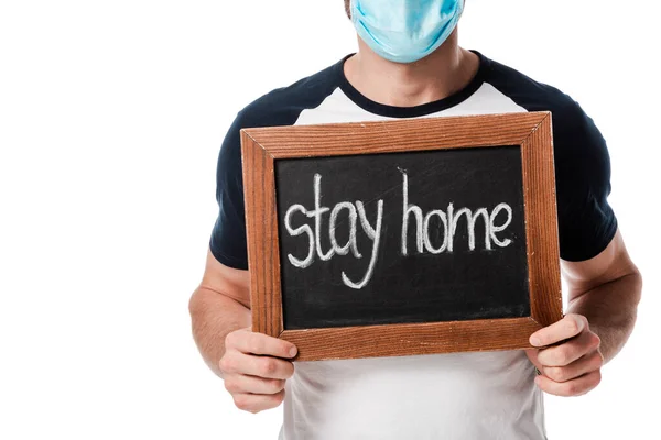 Cropped view of man in medical mask holding chalk board with stay home lettering isolated on white — Stock Photo