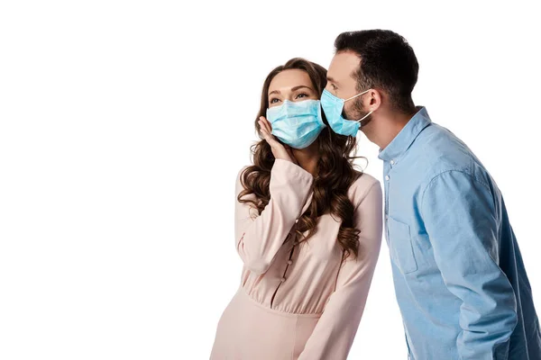 Man kissing woman in medical mask isolated on white — Stock Photo