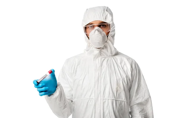 Man in personal protective equipment holding test tube with coronavirus blood sample lettering isolated on white — Stock Photo