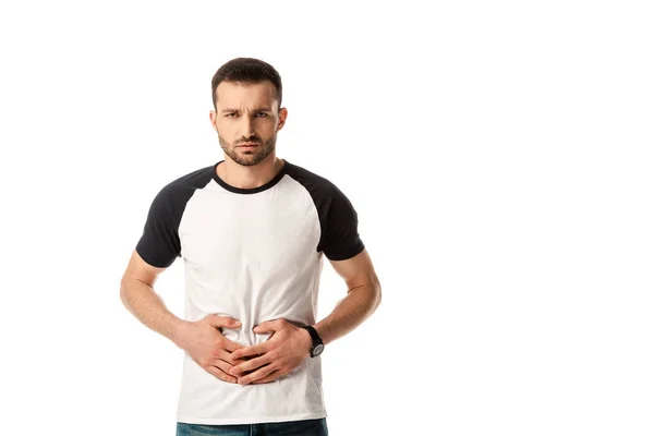 Sick man touching stomach while looking at camera isolated on white — Stock Photo