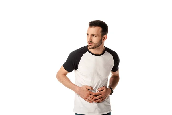 Sick man touching stomach while looking away isolated on white — Stock Photo