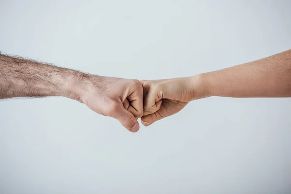Cropped view of men doing fist bump gesture isolated on grey — Stock Photo
