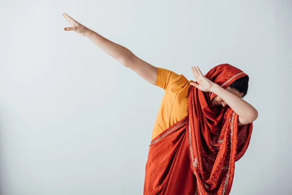 Woman in sari covering face isolated on grey — Stock Photo