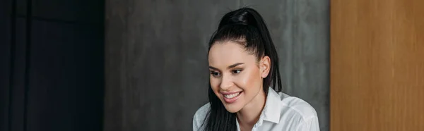 Horizontal image of smiling brunette woman in white shirt — Stock Photo