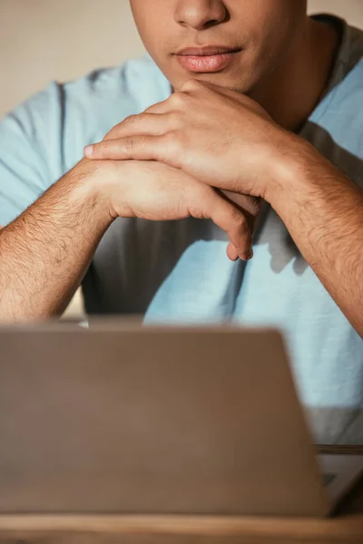 Cropped view of young man using laptop on quarantine, selective focus — Stock Photo