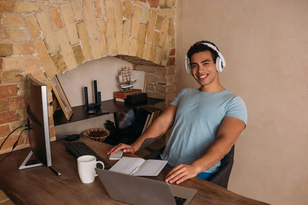 Smiling mixed race freelancer working in home office during quarantine — Stock Photo