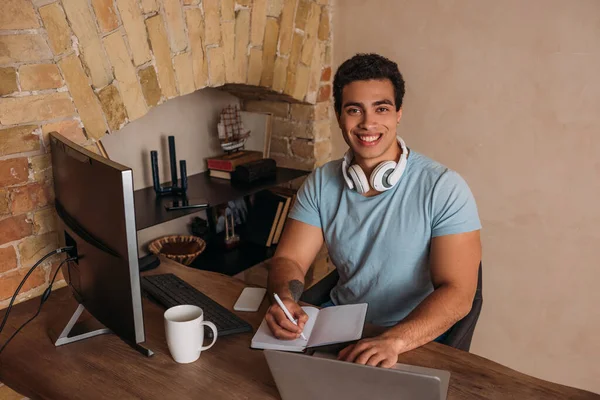 Smiling mixed race freelancer working in home office during self isolation — Stock Photo