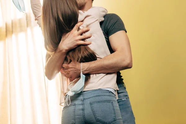 Cropped view of man with medical mask on hand hugging girlfriend, end of quarantine concept — Stock Photo