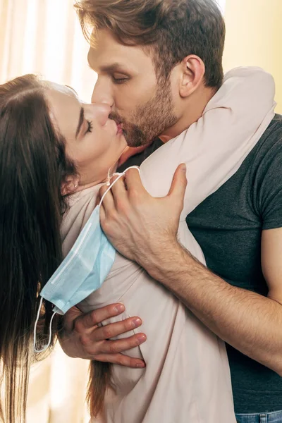 Man kissing with and holding medical mask, end of quarantine concept — Stock Photo