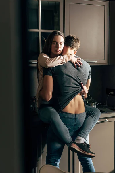 Back view of passionate man hugging girlfriend with closed eyes — Stock Photo