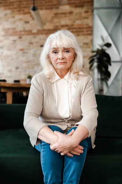 Upset senior woman sitting at home during quarantine — Stock Photo