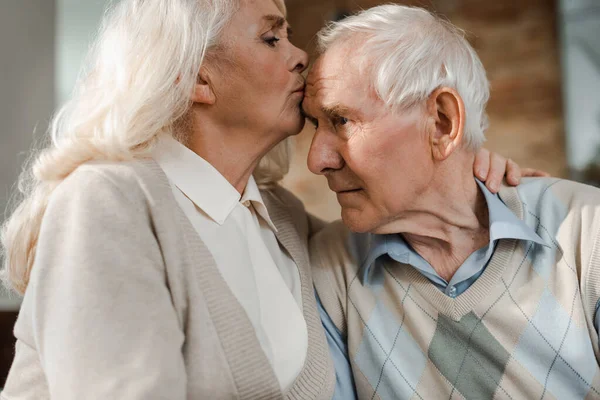 Senior wife checking husband temperature at home on quarantine — Stock Photo