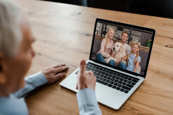 Cropped view of elderly man showing thumb up and having video chat with family during self isolation — Stock Photo