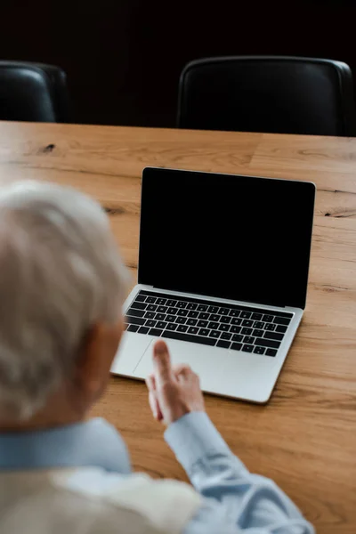 Selective focus of elderly man having video chat on laptop and showing — Stock Photo
