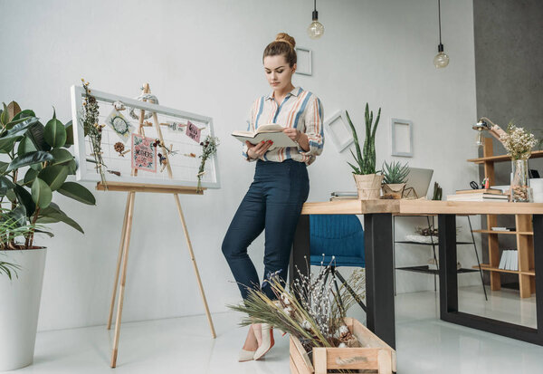 business woman with book in office
