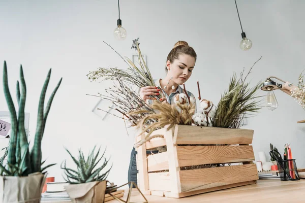 Fleuriste avec des fleurs sur le lieu de travail — Photo