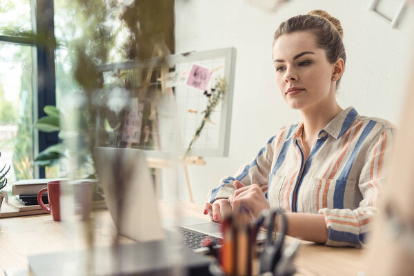 businesswoman with laptop in office