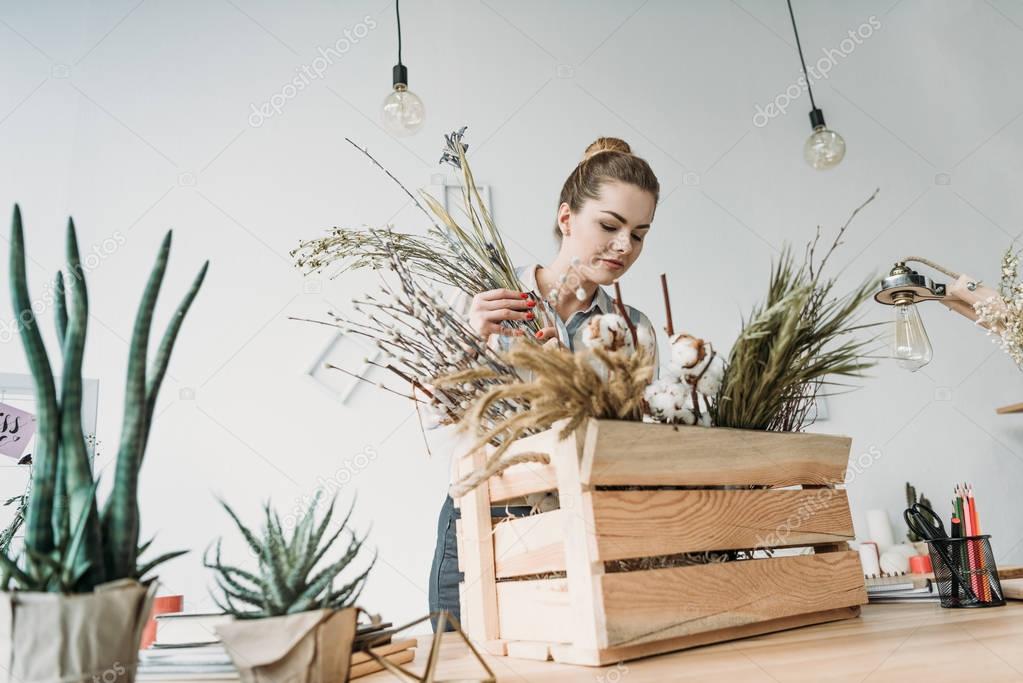 florist with flowers at workplace