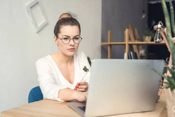 Fiorista con computer portatile sul posto di lavoro — Foto Stock