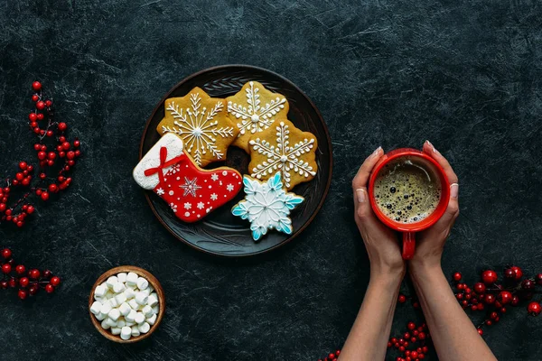 Hands with christmas gingerbreads and coffee — Stock Photo, Image