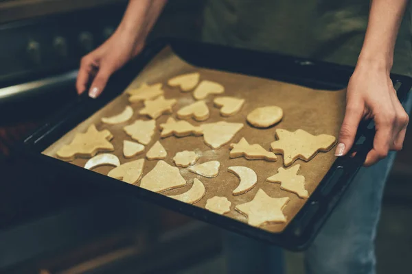 Person baking christmas cookies Royalty Free Stock Images