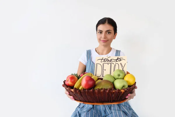 Woman holding basket with harvest — Stock Photo, Image